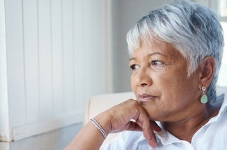 A Hispanic woman gazes out the window