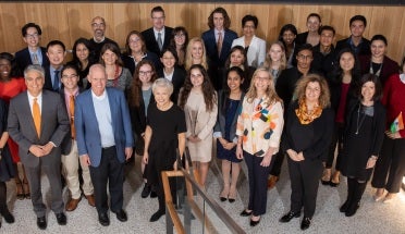the winning teams of the president's award stand with Dr. sonia feigenbaum and president fenves 