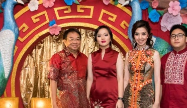 vira poses with her family in indonesia wearing traditional dresses