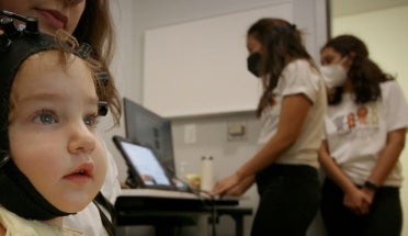 Baby Lena wears a cap that tracks here brain activity
