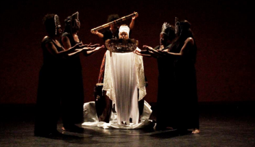 Theatre of the Oppressed members perform on stage. 