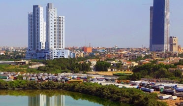 A view of buildings beside a river in Karachi, Pakistan