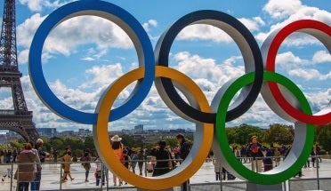Statue of the Olympic Rings next to the Eiffel Tower in Paris