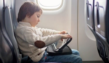 Child sitting in airline seat