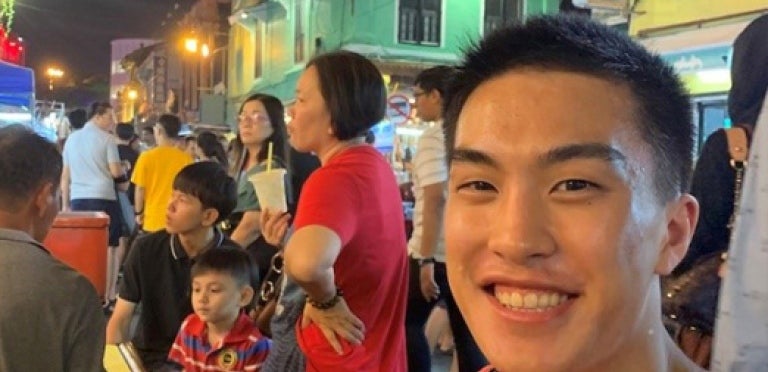 Brandon Chan smiles while studying abroad in Singapore.